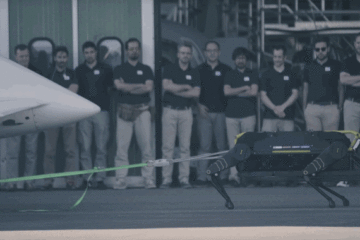 Four-legged Robot pulls Plane